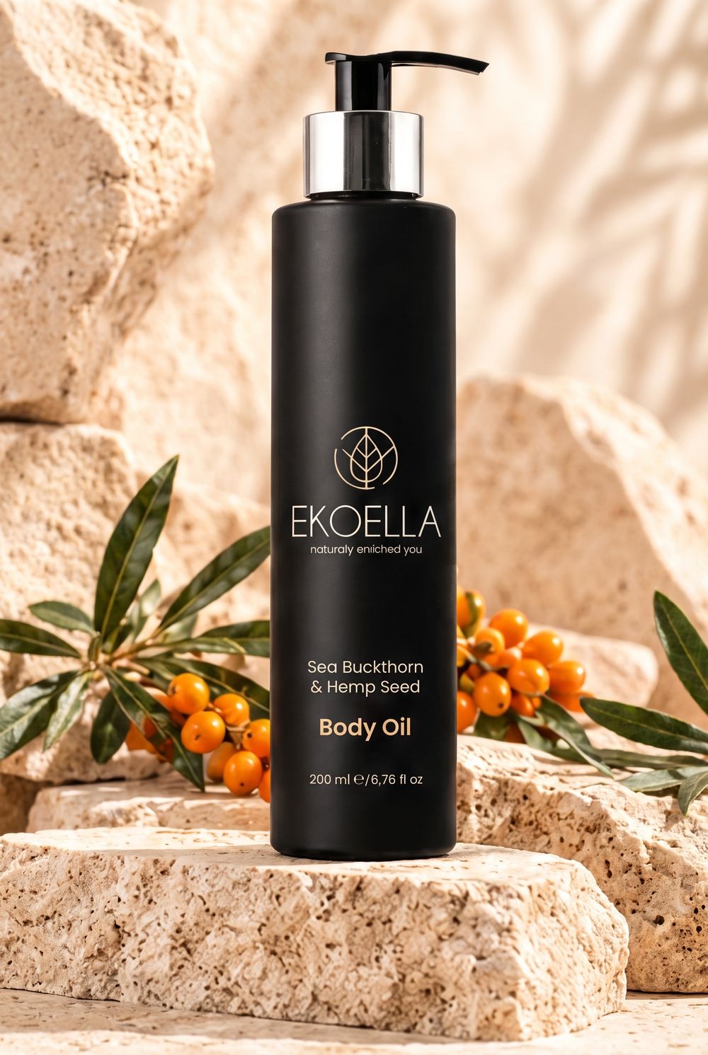 EKOELLA Sea Buckthorn & Hemp Seed Body Oil on a travertine stone with sea buckthorn berries