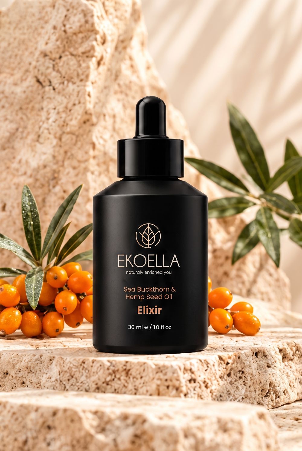 EKOELLA Sea Buckthorn & Hemp Seed Oil Elixir on a travertine stone with sea buckthorn berries